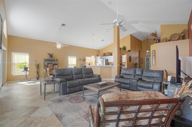 living room with ceiling fan, high vaulted ceiling, and baseboards
