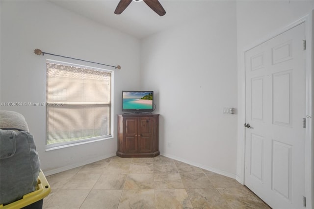 bedroom featuring baseboards and ceiling fan