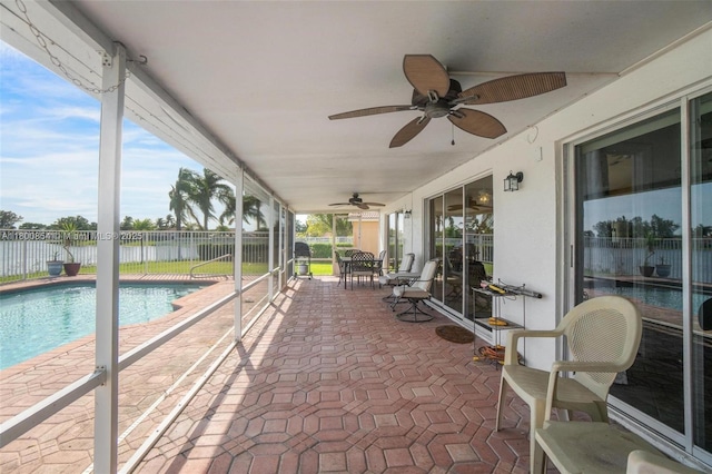view of patio featuring fence, ceiling fan, and a water view
