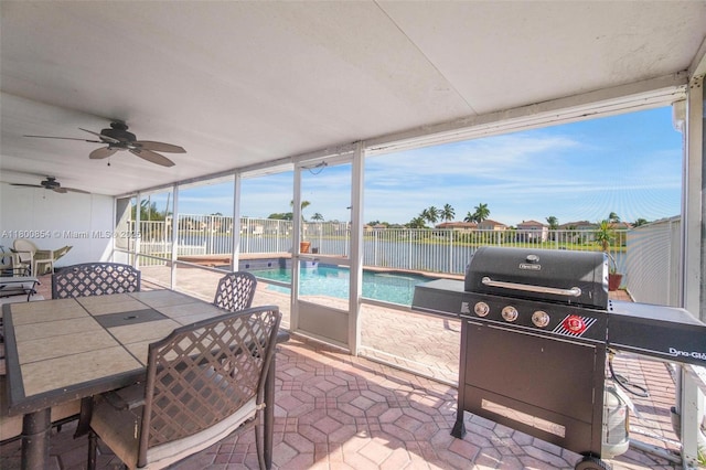 sunroom with ceiling fan and outdoor dining space