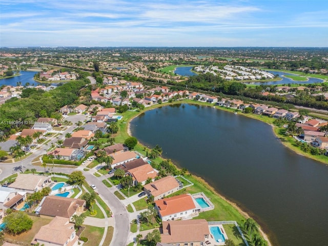 view of property location featuring a large body of water and nearby suburban area