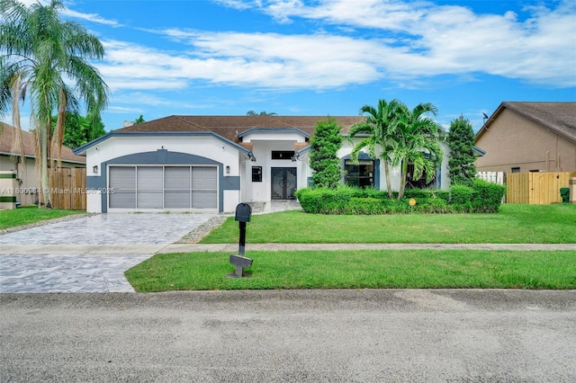 5260 NW 74th Ter, Lauderhill, FL 33319 - ranch-style home with stucco siding, an attached garage, and decorative driveway