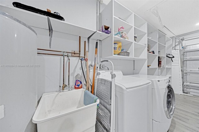5260 NW 74th Ter, Lauderhill, FL 33319 - clothes washing area with washing machine and clothes dryer and wood finished floors