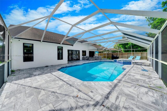 5260 NW 74th Ter, Lauderhill, FL 33319 - view of pool with a patio area, a pool with connected hot tub, a fenced backyard, and glass enclosure
