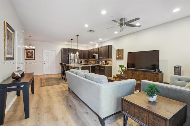 4346 Cascada Cir, Cooper City, FL 33024 - living room featuring light wood-style floors, ceiling fan, recessed lighting, and a chandelier