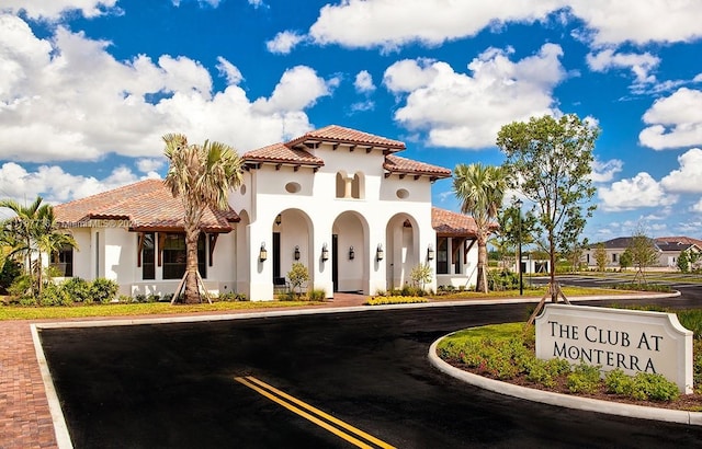 4346 Cascada Cir, Cooper City, FL 33024 - view of front of home with a tiled roof, stucco siding, and uncovered parking