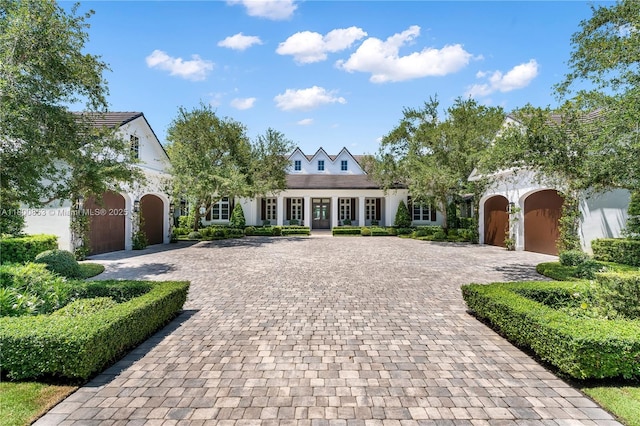 view of front of property featuring decorative driveway and french doors