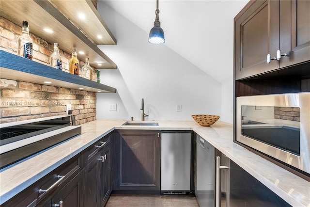 indoor wet bar with stainless steel microwave, decorative backsplash, recessed lighting, and hanging light fixtures