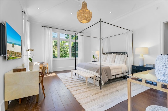 bedroom with wood-type flooring and baseboards