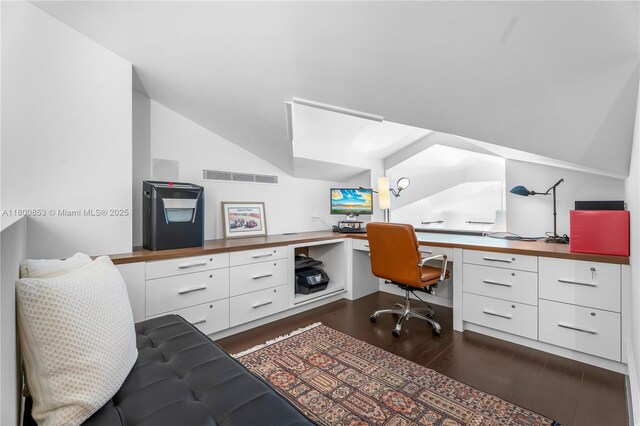 office space featuring built in desk, dark wood-style flooring, and lofted ceiling