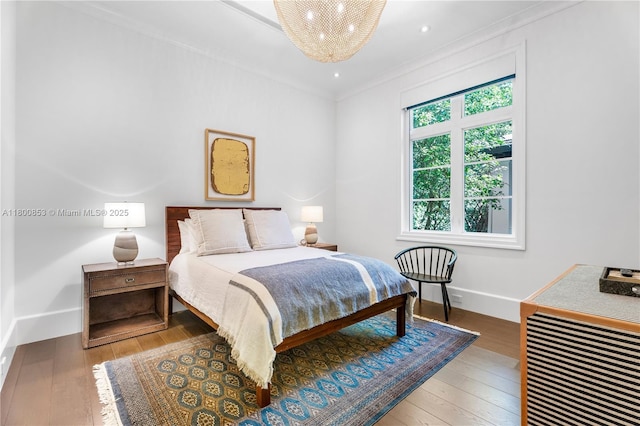 bedroom featuring wood-type flooring, ornamental molding, baseboards, and recessed lighting