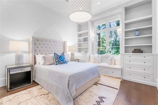 bedroom with dark wood-style flooring and ornamental molding