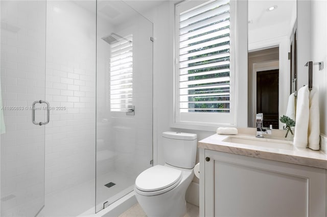 full bath with a shower stall, toilet, and vanity