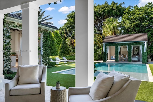 swimming pool featuring a storage structure, an outdoor structure, a patio area, a yard, and an outdoor living space