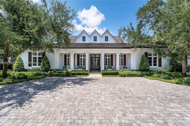 view of front of house featuring covered porch and stucco siding