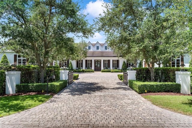 view of home's community featuring decorative driveway