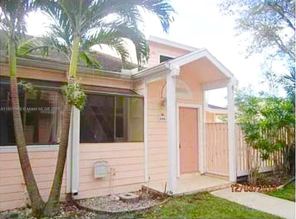 2058 Winners Cir, North Lauderdale, FL 33068 - view of side of property featuring fence and a sunroom