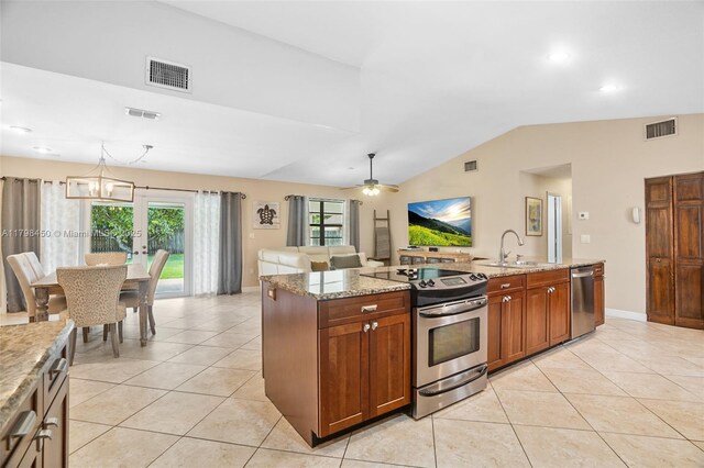 15251 SW 154th Ave, Miami, FL 33187 - kitchen featuring stainless steel appliances, light tile patterned floors, vaulted ceiling, a sink, and light stone countertops