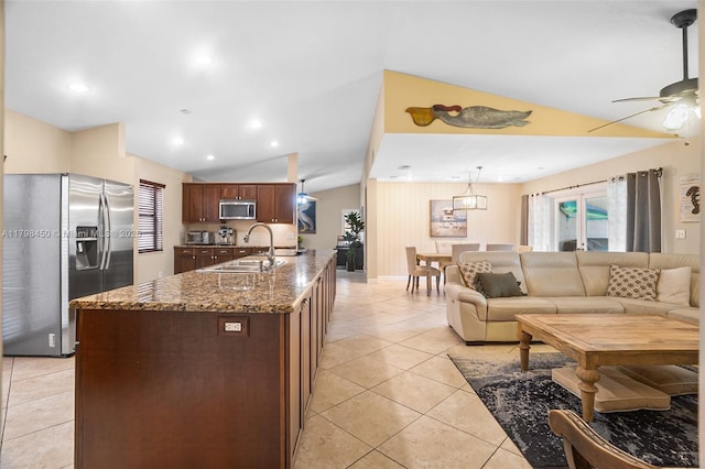 15251 SW 154th Ave, Miami, FL 33187 - kitchen with stainless steel appliances, vaulted ceiling, a sink, a ceiling fan, and dark stone countertops