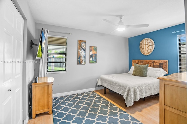 15251 SW 154th Ave, Miami, FL 33187 - bedroom with multiple windows, light wood-style floors, a ceiling fan, and baseboards