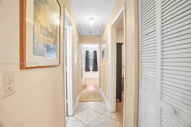 15251 SW 154th Ave, Miami, FL 33187 - corridor featuring light tile patterned floors, baseboards, and attic access