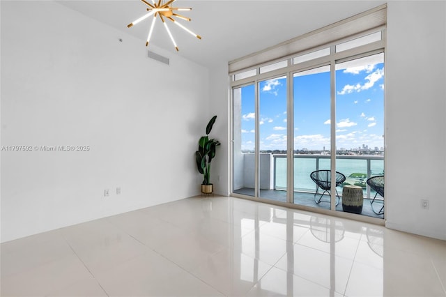 7910 Harbor Island Dr Unit 1208, North Bay Village, FL 33141 - tiled spare room featuring healthy amount of natural light, a chandelier, expansive windows, and a water view