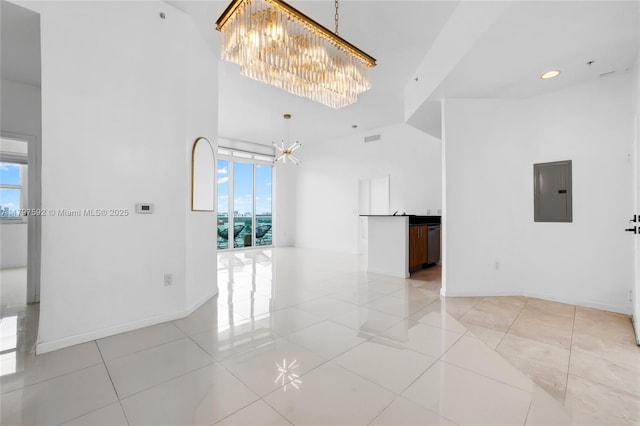 7910 Harbor Island Dr Unit 1208, North Bay Village, FL 33141 - unfurnished room with a chandelier, electric panel, baseboards, light tile patterned flooring, and a high ceiling