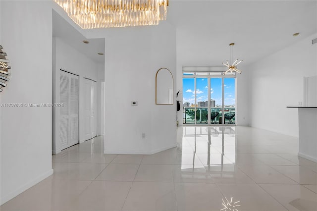7910 Harbor Island Dr Unit 1208, North Bay Village, FL 33141 - unfurnished room with a chandelier, light tile patterned flooring, baseboards, and a towering ceiling