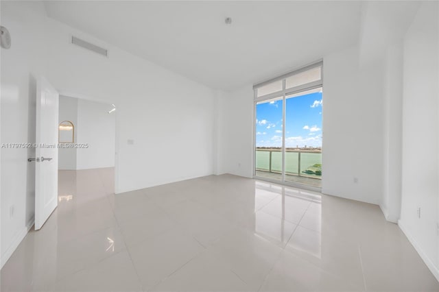 7910 Harbor Island Dr Unit 1208, North Bay Village, FL 33141 - unfurnished room with a wall of windows and tile patterned floors