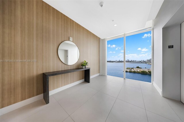 7910 Harbor Island Dr Unit 1208, North Bay Village, FL 33141 - hall featuring a water view, baseboards, floor to ceiling windows, elevator, and light tile patterned floors