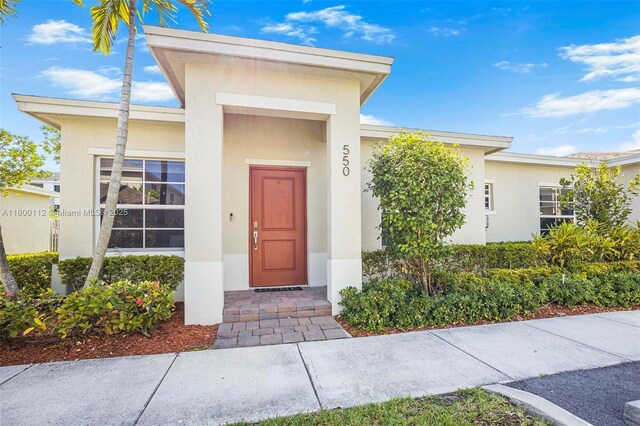 550 NE 4th Ave, Florida City, FL 33034 - view of exterior entry with stucco siding