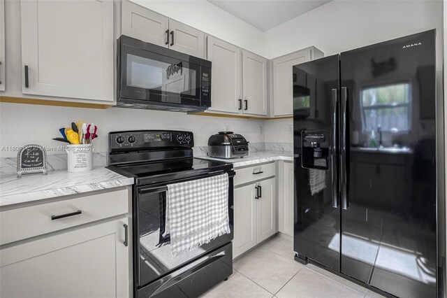 550 NE 4th Ave, Florida City, FL 33034 - kitchen featuring black appliances, a sink, light tile patterned floors, recessed lighting, and light stone counters