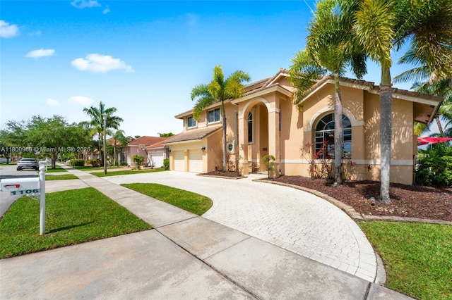 1106 NW 180th Ave, Pembroke Pines, FL 33029 - mediterranean / spanish home featuring curved driveway, stucco siding, an attached garage, and a front yard
