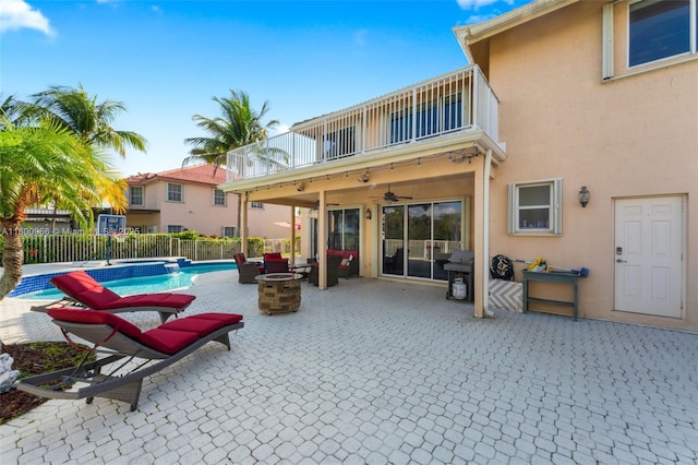 1106 NW 180th Ave, Pembroke Pines, FL 33029 - view of swimming pool with fence, an outdoor fire pit, a ceiling fan, and a patio area