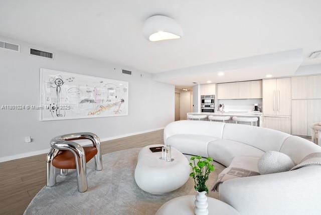 488 NE 18th St Unit 715, Miami, FL 33132 - living room with baseboards, wood finished floors, and recessed lighting