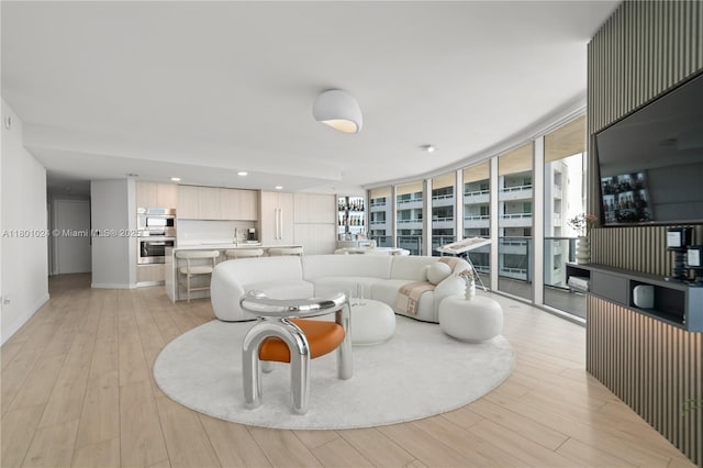 488 NE 18th St Unit 715, Miami, FL 33132 - living area with light wood-style floors, healthy amount of natural light, and expansive windows