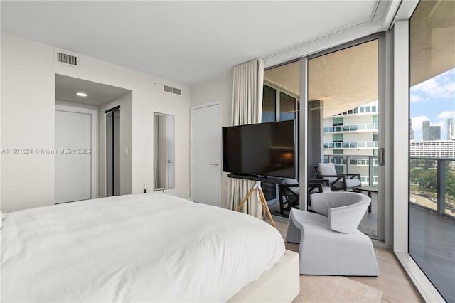 488 NE 18th St Unit 715, Miami, FL 33132 - bedroom with access to outside, wood finished floors, and expansive windows