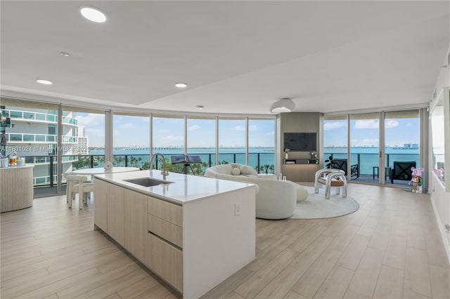 488 NE 18th St Unit 715, Miami, FL 33132 - kitchen with a sink, modern cabinets, light wood finished floors, floor to ceiling windows, and open floor plan