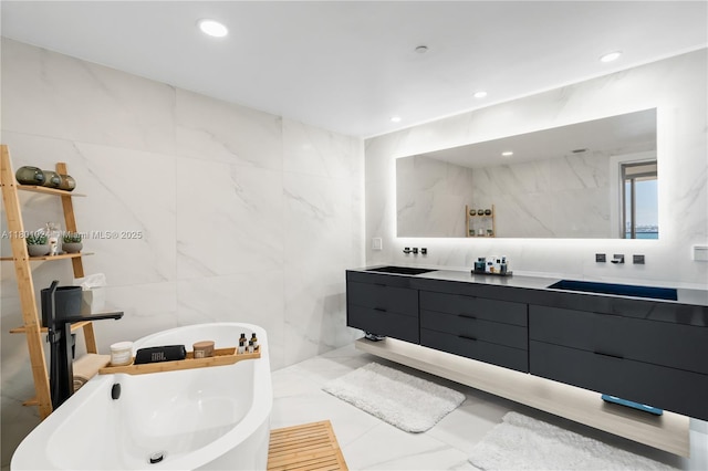 488 NE 18th St Unit 715, Miami, FL 33132 - bathroom featuring tile walls, double vanity, a freestanding tub, and recessed lighting