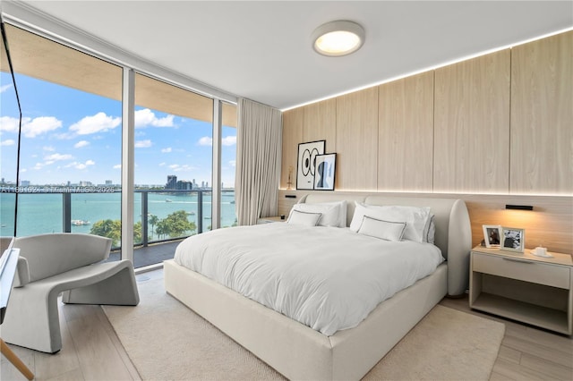 488 NE 18th St Unit 715, Miami, FL 33132 - bedroom featuring a water view, access to exterior, expansive windows, light wood finished floors, and a view of city