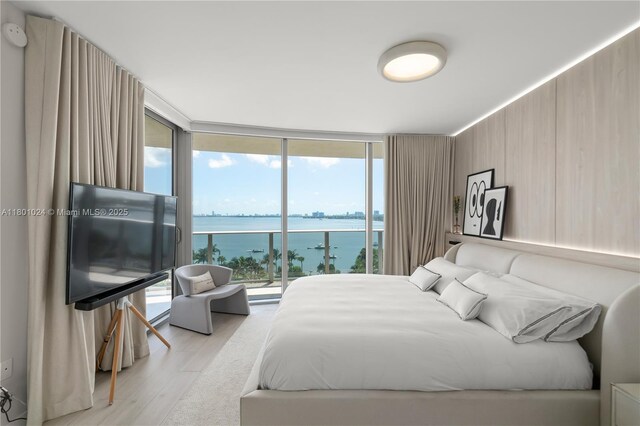 488 NE 18th St Unit 715, Miami, FL 33132 - bedroom featuring access to exterior, light wood-type flooring, and floor to ceiling windows