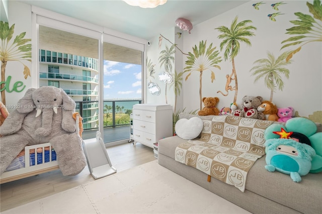 488 NE 18th St Unit 715, Miami, FL 33132 - living room featuring a water view, a wall of windows, and wood finished floors