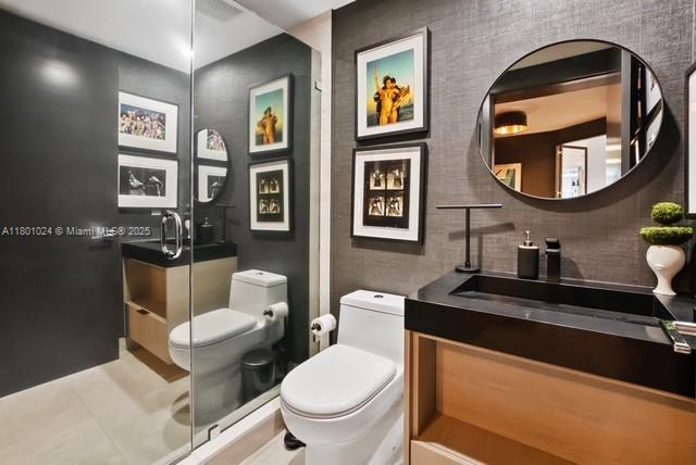 488 NE 18th St Unit 715, Miami, FL 33132 - full bathroom with toilet, vanity, a stall shower, tile patterned flooring, and decorative backsplash