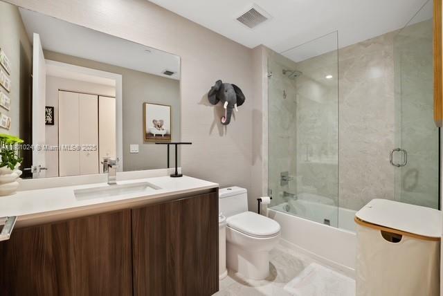 488 NE 18th St Unit 715, Miami, FL 33132 - bathroom with toilet, vanity, and bath / shower combo with glass door