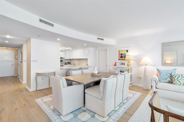 9401 Collins Ave Unit 505, Surfside, FL 33154 - dining area with light wood finished floors, baseboards, and recessed lighting