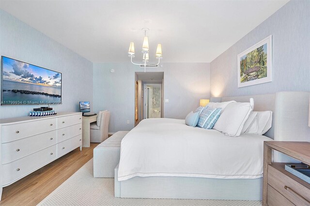9401 Collins Ave Unit 505, Surfside, FL 33154 - bedroom with wood finished floors and a chandelier