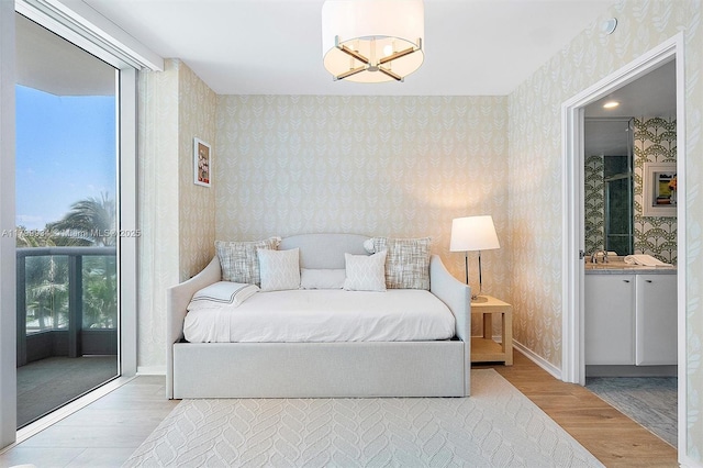 9401 Collins Ave Unit 505, Surfside, FL 33154 - bedroom with wood finished floors, wallpapered walls, and baseboards