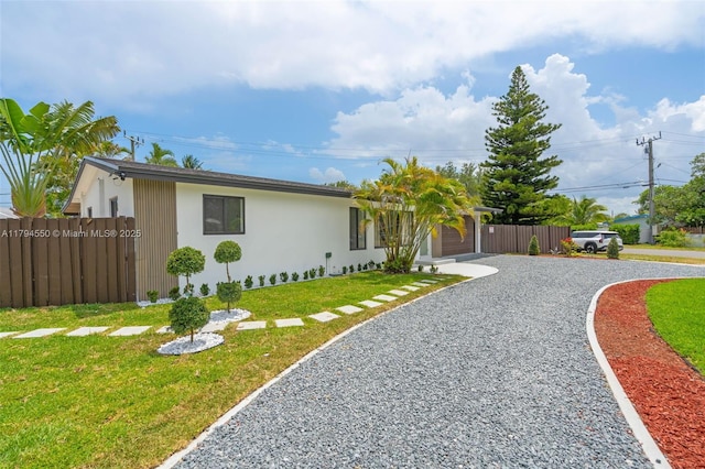 ranch-style house with driveway and stucco siding