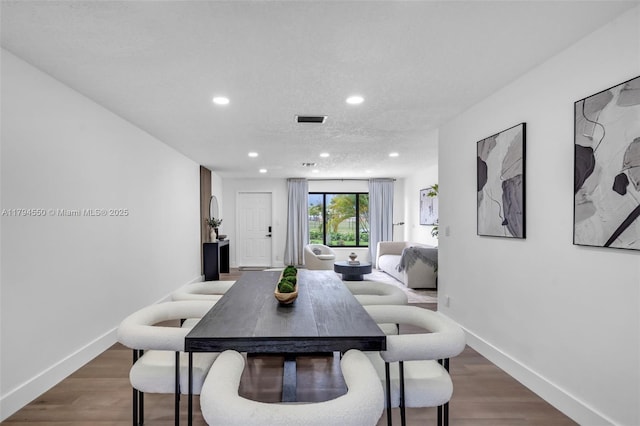 dining area with recessed lighting, wood finished floors, and baseboards