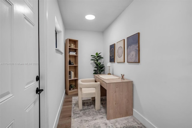 office area with baseboards and wood finished floors